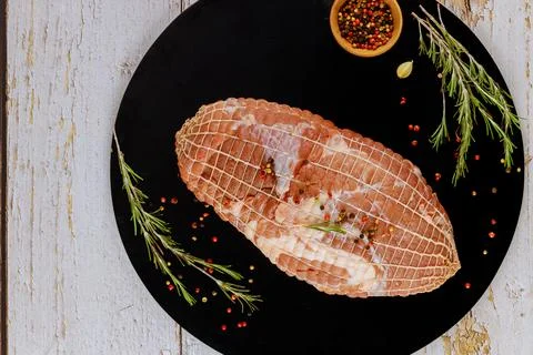 Preparing pork shoulder meat for roasting with spices. Stock Photos