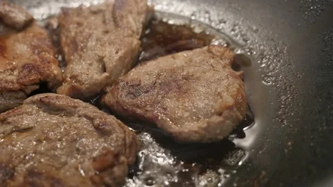 Preparing of pork steaks in frying pan Stock Footage 88387110