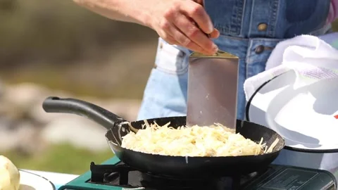 Preparing potato rosti in a cooking pan Stock Footage 133749583
