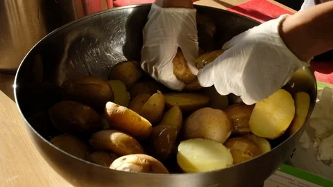 Preparing potatoes for baking and rubbing potatoes with oil. Close-up of hands Stock Footage 91194665