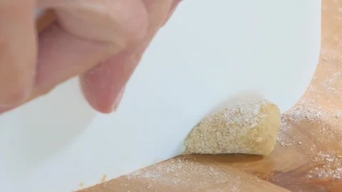 Preparing potatoes Gnocchi. Cut little pieces of potatoes dough. Italian food Stock Footage 104549532