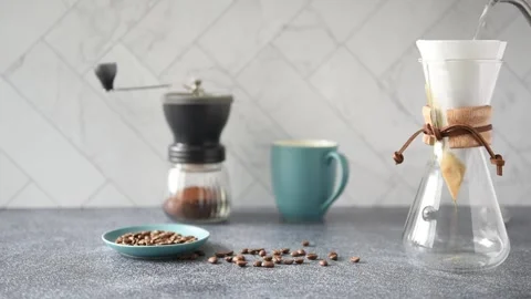 Preparing Pour-over Coffee on a bright kitchen counter with marble backsplash Stock Footage 233112458