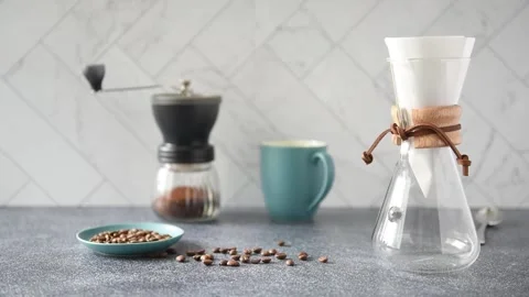 Preparing Pour-over Coffee on a bright kitchen counter with marble backsplash Stock Footage 233112474