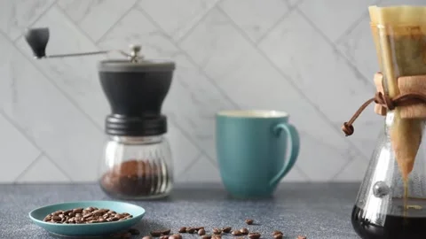 Preparing Pour-over Coffee on a bright kitchen counter with marble backsplash Stock Footage 233112485