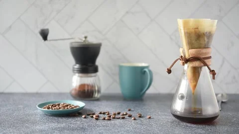 Preparing Pour-over Coffee on a bright kitchen counter with marble backsplash Stock Footage 233112693