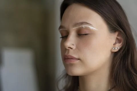 Preparing for the procedure of coloring the eyebrows white pencil near the Stock Photos