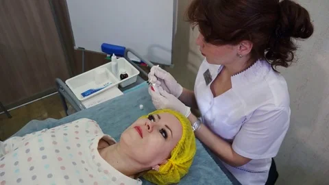 Preparing for the process of biorevitalization. Application of cream for Stock Footage 77628280