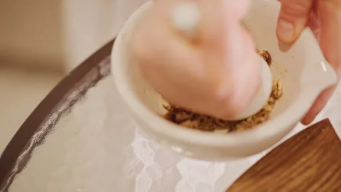 Preparing pumpkin crust by hand. Using mortar and pestle to grind nuts Stock Footage 346398680