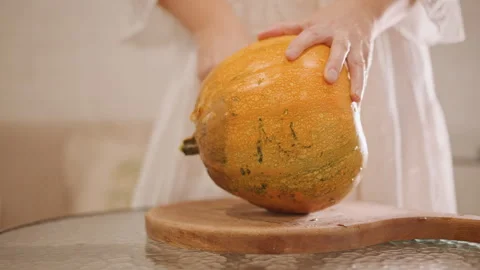 Preparing pumpkin filling with hands in warm kitchen setting. Home baker Stock-Footage 346409832