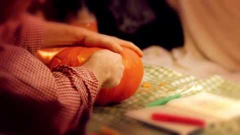 Preparing pumpkin for Halloween. Scooping out guts and seeds with spoon. Woma Video stock 272461868