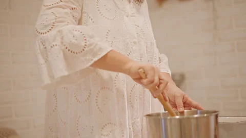 Preparing pumpkin pie with careful hand movements and cozy ambiance. Cozy Stock Footage 346395842