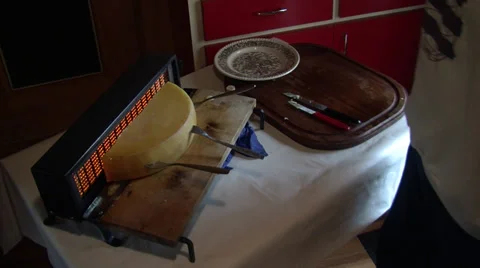 Preparing a raclette cheese dish Stock Footage 32509167