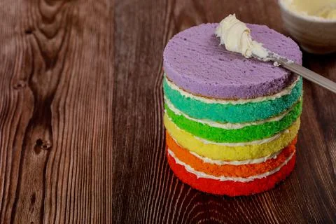 Preparing rainbow sponge cake for birthday party. Stock Photos