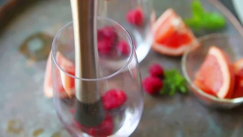 Preparing raspberry grapefruit drink Stock Footage 77194269