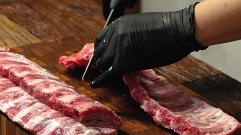 Preparing Raw Beef Ribs on Wooden Cutting Board Close Up 動画素材 335733025