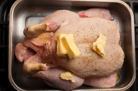 Preparing a raw chicken for roasting Stock Photos
