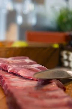 Preparing raw pork ribs for cooking in kitchen Stock Photos