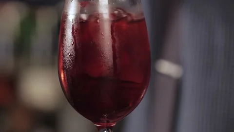 Preparing a red non alcohol cocktail with a slice of lemon. Stock Footage 136519375