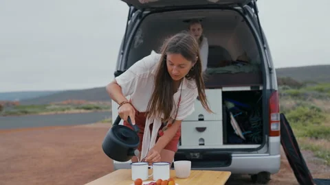 Preparing a refreshing tea or coffee during a summer van trip Stock Footage 297063706