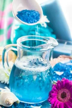 Preparing relaxing spa bath aromatic pouring salt Stock Photos