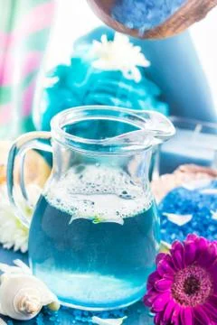 Preparing relaxing spa bath aromatic pouring salt Stock Photos