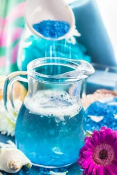 Preparing relaxing spa bath aromatic pouring salt Stock Photos