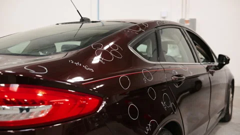 Preparing to Repairing Hail Damage in car body shop Stock Footage 332183302
