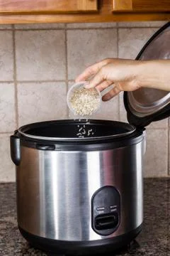 Preparing rice in cooker Stock Photos