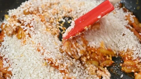 Preparing a rich paella, adding the rice Stock Footage 219717404