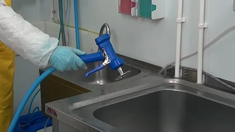 Preparing to Rinse in an Industrial Sanitation Facility Stock Footage 325847824