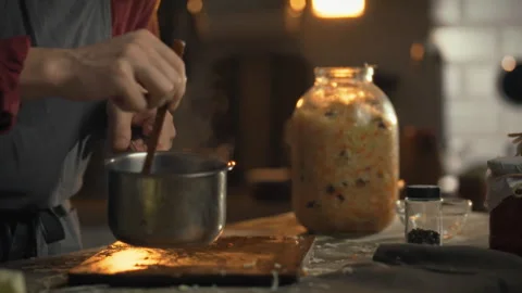 Preparing rosol for seasoned cabbage fermentation in a cozy kitchen setting 스톡 동영상 331357143
