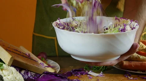 Preparing salad in kitchen, mixes chopped red and white cabbage, dolly Stock Footage 60579916