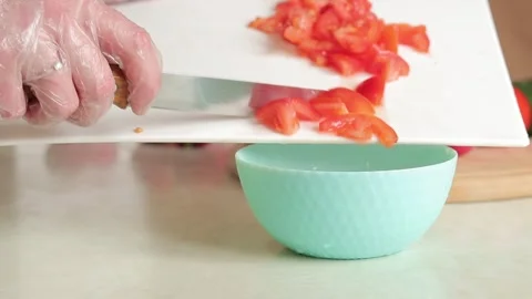 Preparing a salad, pour the chopped tomatoes into a deep plate Stock Footage 241585348