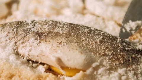 Preparing salt-crusted fish Stock Footage 125458580