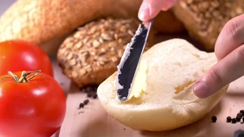 Preparing sandwich on breakfast table full of vegtables.  Stock Footage 138294667