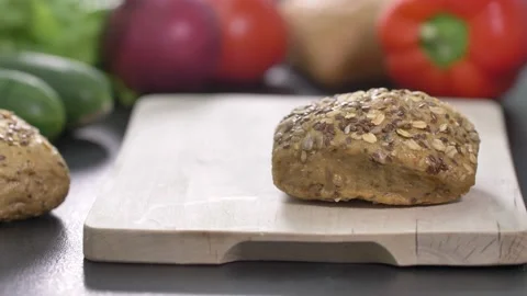 Preparing sandwich on breakfast table full of vegtables.  Video stock 138385535