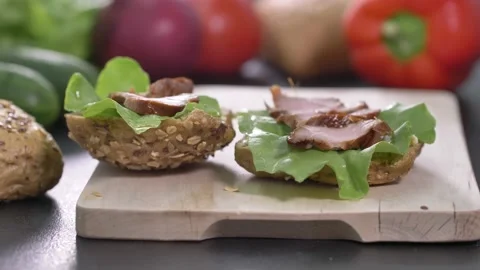 Preparing sandwich on breakfast table full of vegtables.  Stock Footage 138387203