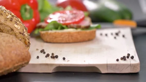 Preparing sandwich on breakfast table full of vegtables. Video stock 138403996