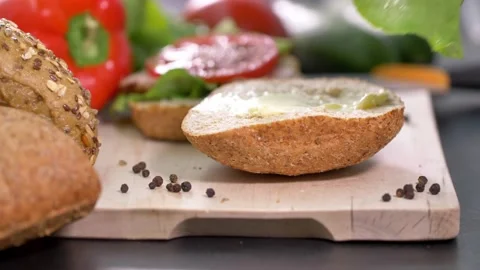 Preparing sandwich on breakfast table full of vegtables. Stock Footage 138404149