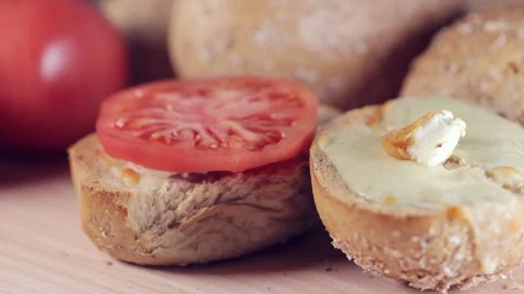 Preparing sandwich on breakfast table full of vegtables.  Vídeos de archivo 154458844