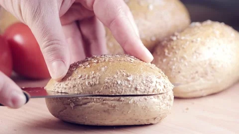 Preparing sandwich on breakfast table full of vegtables.  Vídeos de archivo 154459297
