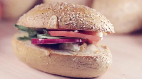 Preparing sandwich on breakfast table full of vegtables.  Vídeos de archivo 154459412