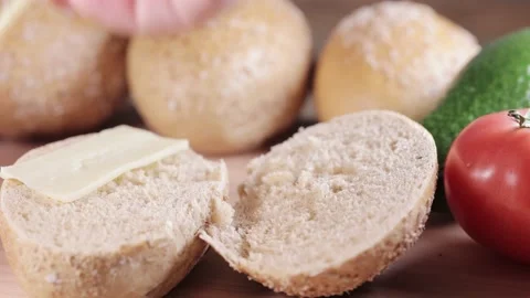 Preparing sandwich on breakfast table full of vegtables.  Vídeos de archivo 154459780