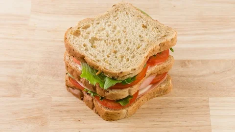 Preparing sandwich with tomato, ham, cheese and salad stop motion Stock Footage 77876485