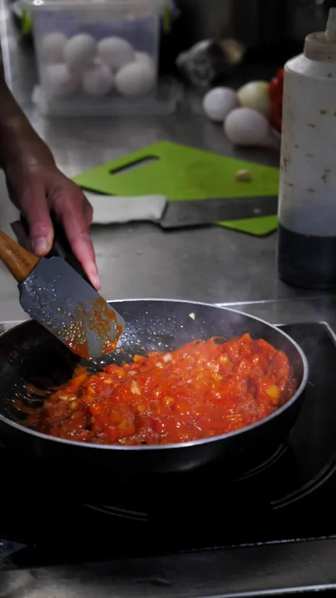 Preparing a sauce of fresh tomatoes, sweet or hot peppers, onions and spices Stock Footage 313939099