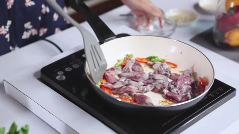 Preparing Savory Spicy Squid with Garlic and Chili in a Bright Kitchen Video stock 334916028