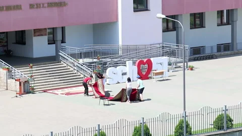Preparing for school graduation 2020 in Belarus. Workers lay in front of the  Stock Footage 132412555