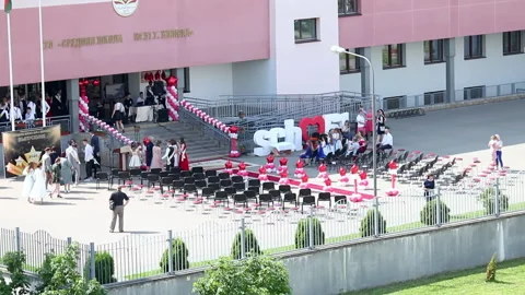 Preparing for the school graduation celebration. Graduates gather for a meeti Stock Footage 132412892