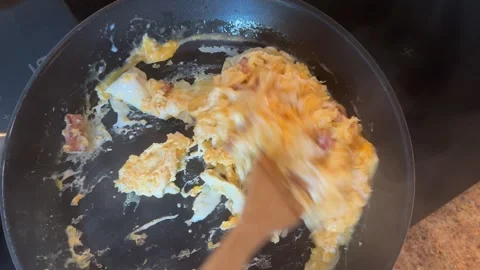 Preparing Scrambled Eggs with Bacon for Breakfast Video stock 278169171