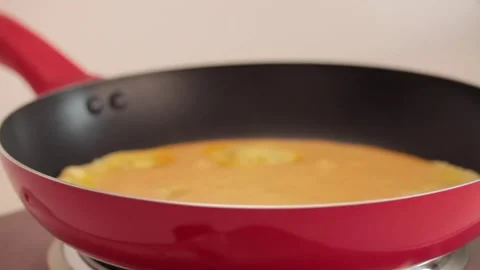 Preparing scrambled eggs in a cooking pan Stock Footage 133814711